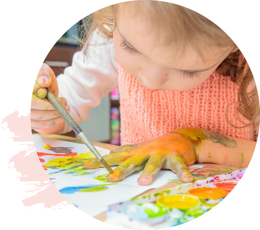 A child is painting with paint and scissors.