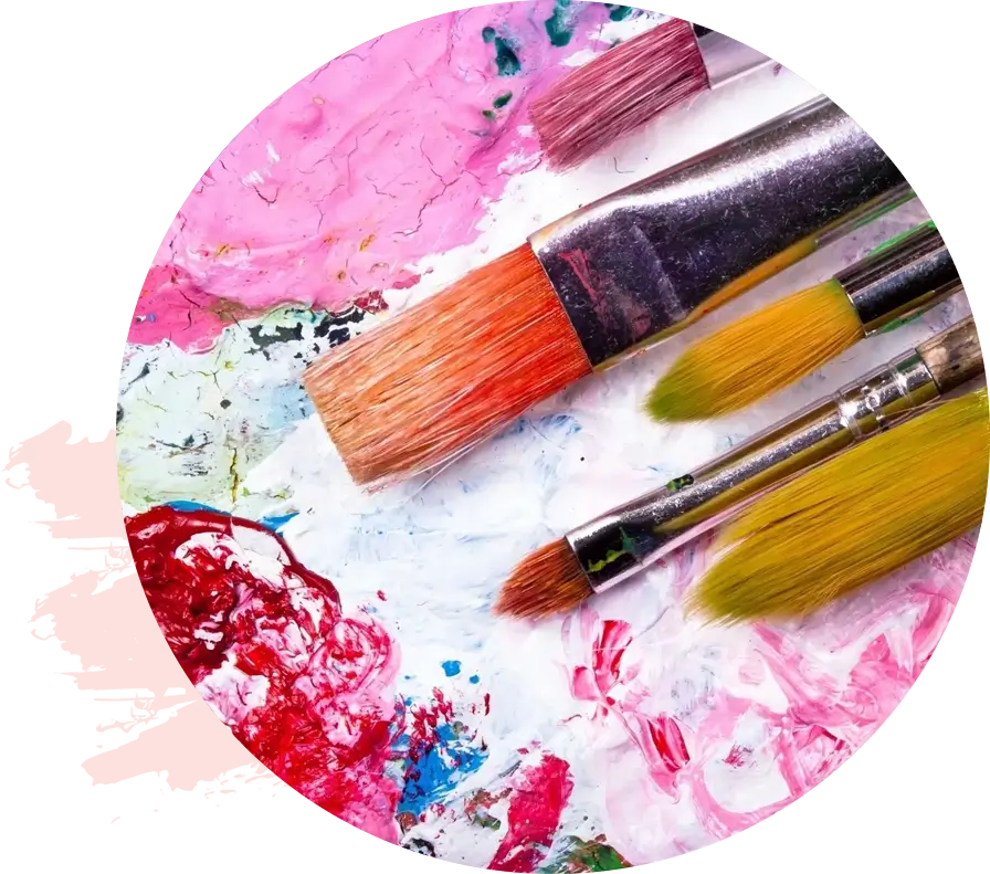 Three paintbrushes with different colored bristles rest on a colorful, paint-smeared palette, embodying the essence of healing through art.